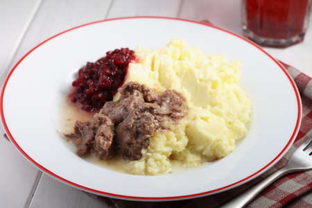 Finnish dinner with venison meat, mashed potato and lingonberry jam