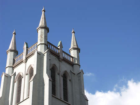 top of a church against a blue sky with clouds (horizontal)の写真素材