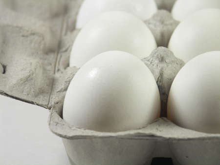 carton of a dozen eggs with focus on front left corner of carton