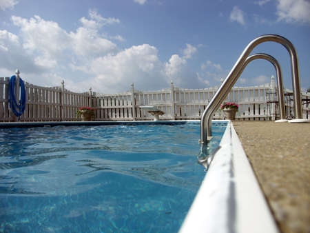 Ladder and diving board of an inground pool. Focus on ladder.の写真素材