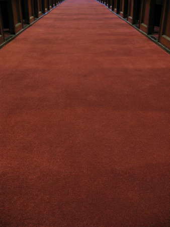 Low angle of a red carpet down an aisle.の写真素材