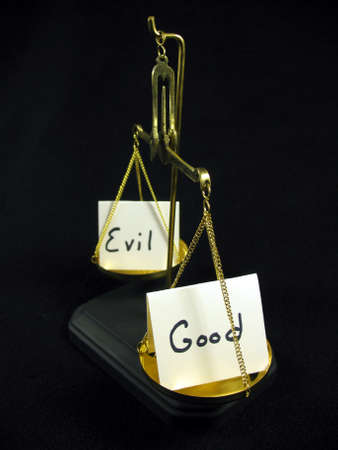 Good and evil cards on a gold scale. 