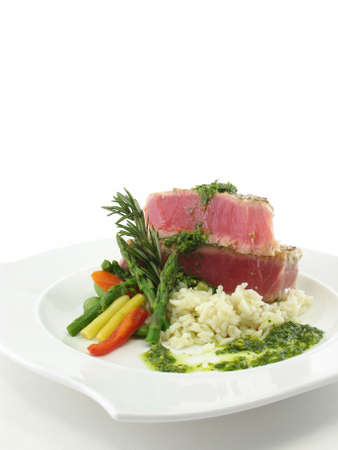 Tuna steak on a white plate isolated on white.の写真素材