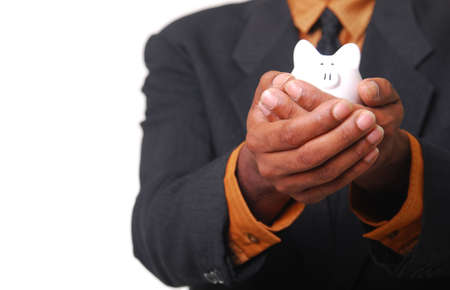 African-American male hands cradling a piggy bank.の写真素材