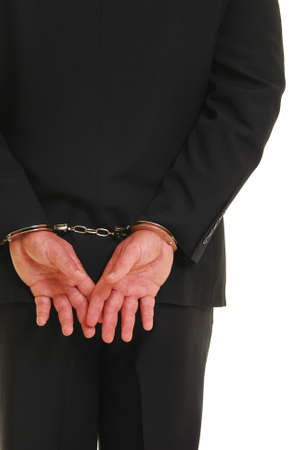 Business man in handcuffs isolated on white