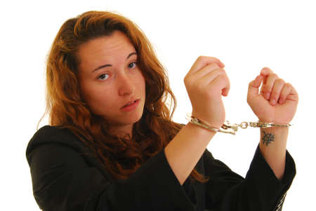 Attractive young woman in suit with handcuffs.の写真素材