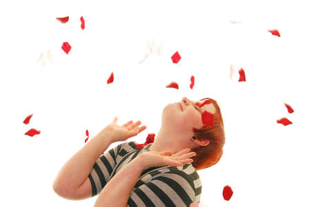 Attractive Caucasian woman being showered with flower petalsの写真素材