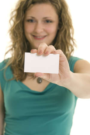 Attractive Caucasian woman holding blank business card. Shallow DOF. Focus on card.の写真素材