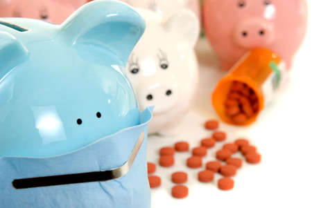 Piggy bank wearing a mask with pills and bottle in a swine flu conceptの写真素材