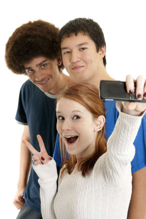Three teens of different ethnic backgrounds smiling for the camera phoneの写真素材