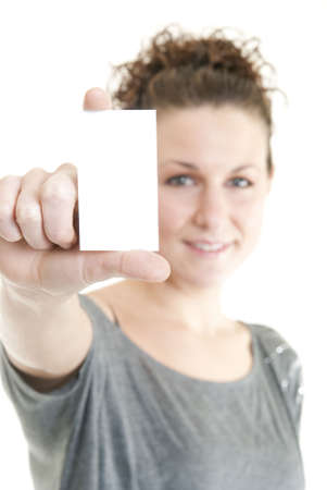 Attractive woman holding blank business card. Focus on hand and card.の写真素材