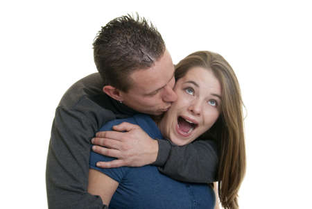 Caucasian male kissing his girlfriend