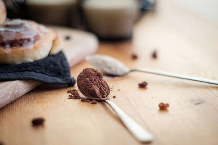 Close up photo of a spoon of cocoa powder on the tableの写真素材