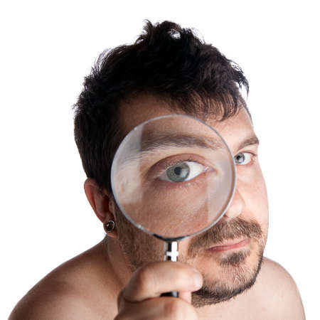 Self portrait of a man looking though a magnifying glass  の写真素材