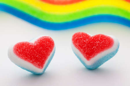 Two candy hearts with a blurred rainbow flag の写真素材