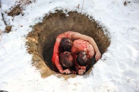 UNGURTAS, KAZAKHSTAN - JANUARY 4: Pilgrims in the hole covered with sheep's blood as cleansing ritual of the last Kazakhstan dervish Bifatima-apa in Ungurtas. January 4, 2011のeditorial素材