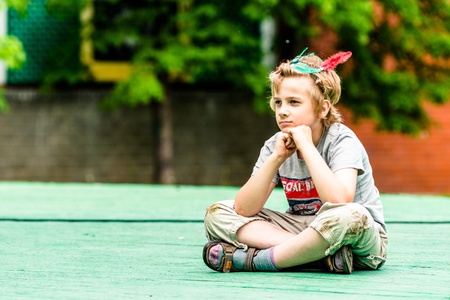 MOSCOW, RUSSIA - 18 MAY: Unidentified boy watching annual carnival in Moscow in Ermitage Garden sitting on stage. Moscow, 18 may, 2013のeditorial素材