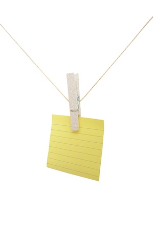 Yellow lined note on a string on a white isolated backgroundの写真素材