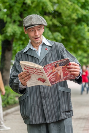 MOSCOW, RUSSIA - Retro festival 'Days of history' in Hermitage Garden. Old fashioned soviet man reading Playboy. Moscow, May 26, 2013のeditorial素材