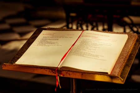 Open Bible book on Evangelie page in church in Bruges, Belgiumのeditorial素材
