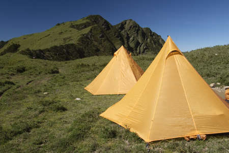 Two yellow tents just standing on grassland in Taiwan National Park.の写真素材