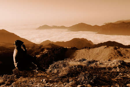 A man sit down and thing of something in outdoor.の写真素材