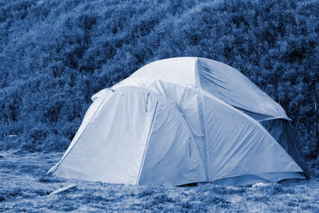A forzen small tent in cold high moutain.の写真素材