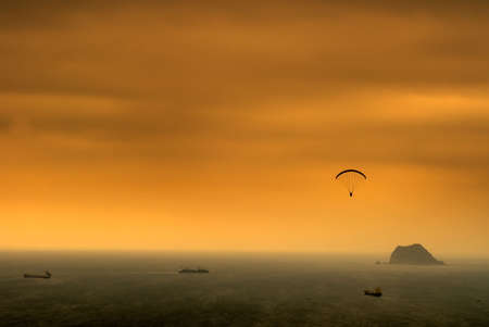 It is a kind of sport called parachuting over the sea.