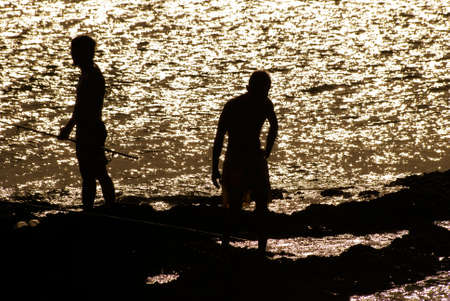 Here are two friends standing on the rock coach.の写真素材