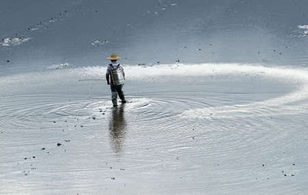 It is a farmer spray insecticide with traditional way on the farm.の写真素材