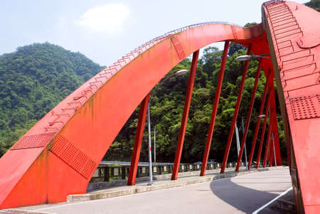 Here is a red big bridge on the land.の写真素材