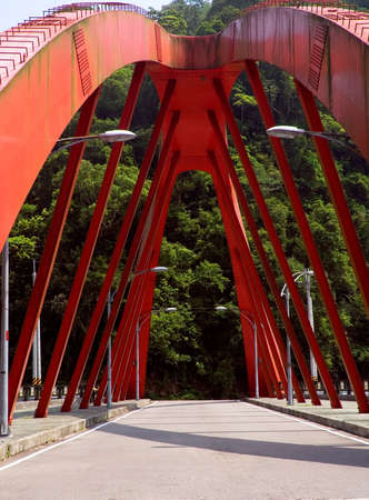Here is a red big bridge on the land.の写真素材