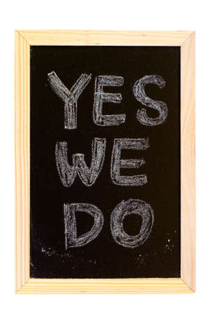 It is a blackboard written "Yes,we do" slogan.の写真素材
