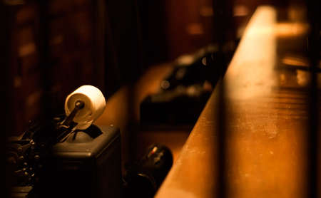 It is an old typewriter for bank on the desk.の写真素材