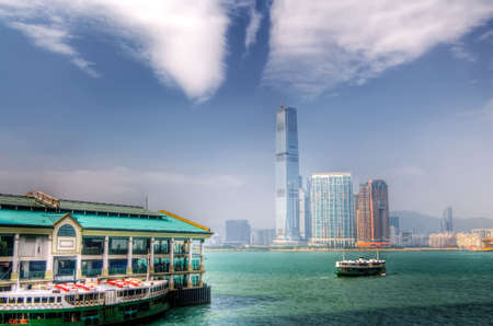 one ferry berthed at Victoria Harbor and another one far away on the sea in Hong Kong.