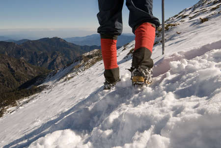 Mountain climber foot walk on snow slap.の写真素材