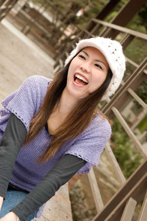 Happy Asian woman in modern style laughing in outdoor.