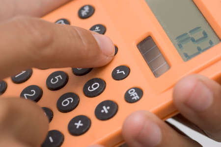 Business man use calculating machine with finger.の写真素材