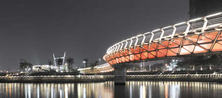 Panorama cityscape of night with color bridge in Kaohsiung, Taiwan.