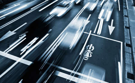 Traffic rush time with cars motion blurred in modern city.