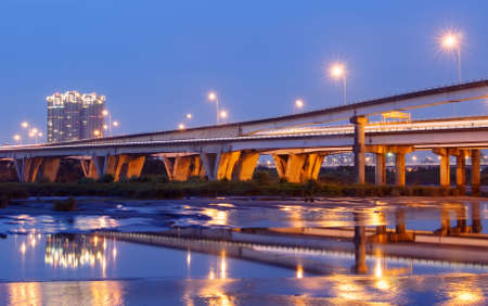 Color city scenic with modern bridge and light over river.の写真素材
