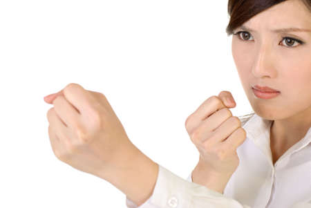 Businesswoman fight pose with confident expression on white background.の写真素材