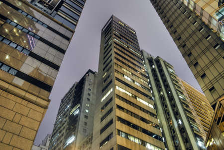 Skyscraper tower of tall in night with yellow color.の写真素材