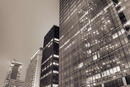 Cityscape of modern building exterior with glass windows in night.の写真素材