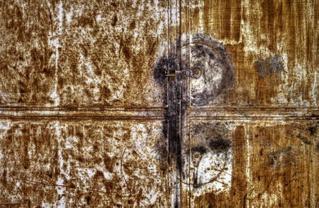Rusty metallic door background with one lock.の写真素材