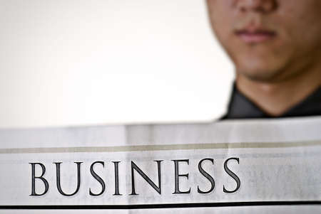 Business man read newspaper, focus on business words.の写真素材