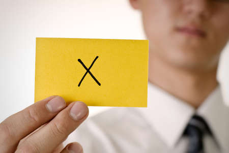 Reject pattern on yellow card hold by business man.の写真素材