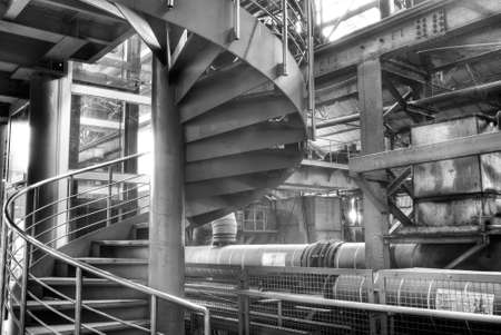 Interior of old factory with metal circle stair.の写真素材