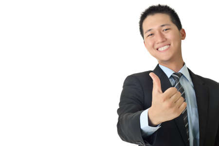 Smiling young businessman give you a excellent sin with copyspace on white.の写真素材