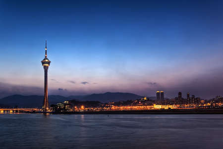 Cityscape in night with famous travel tower near river in Macao, China.のeditorial素材